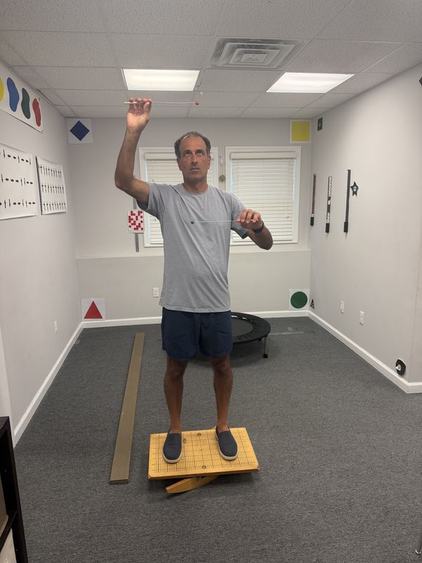 Balance and visual tracking exercise at Empowered Learning Transformational Centers